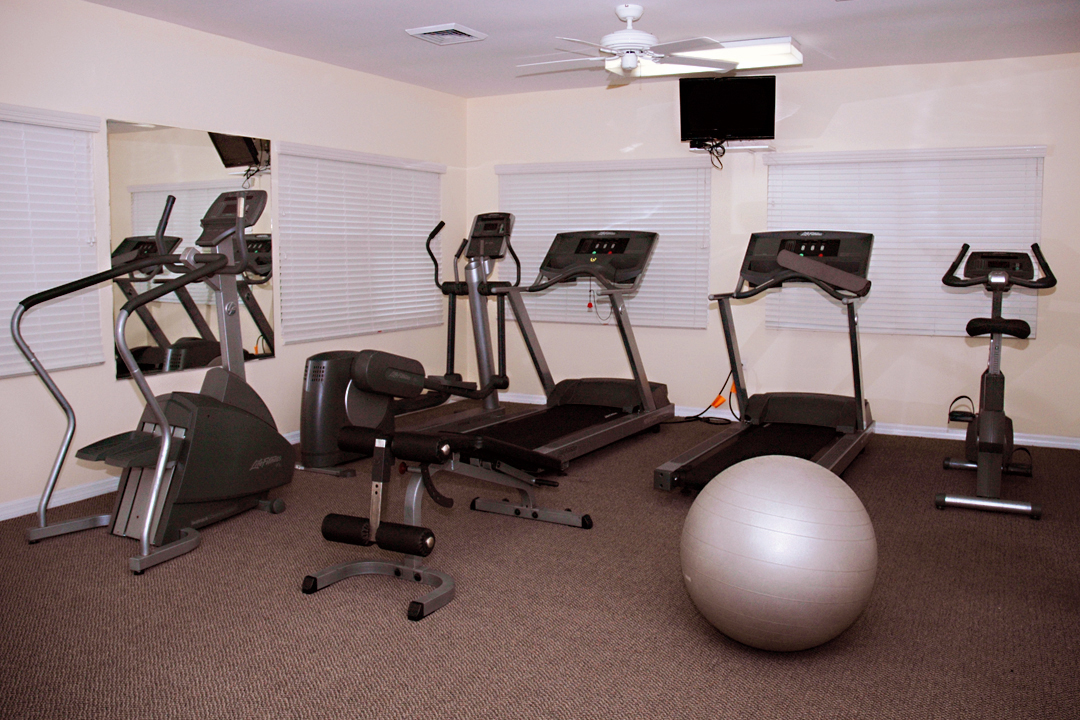 Cayman Club fitness center with ocean views