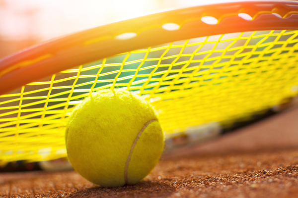 Tennis racket and ball on Cayman Club tennis courts